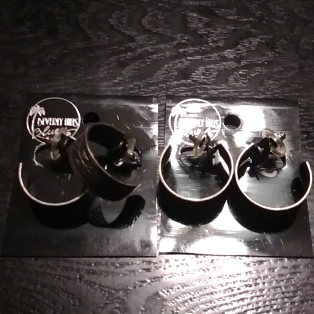 Metal post earrings with Mayan like symbols on outside of hoops